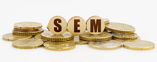 On a white surface lie coins and circles with the inscription - SEM