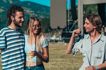 Friends drinking beer and having fun at music festival