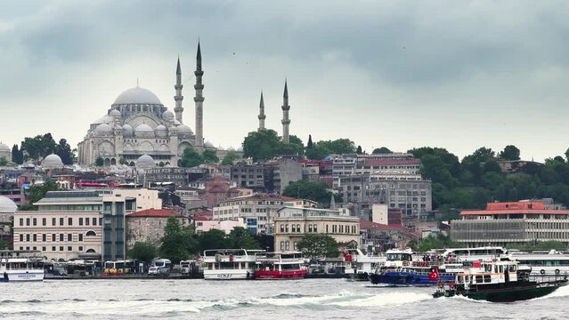 View of the Suleymaniye Mosque and fishing boats in Eminonu, Istanbul, Turkey