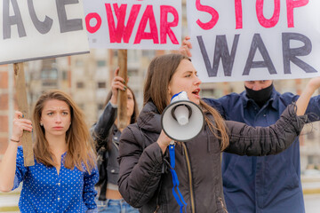 Protesting against the war together on the street while shouting, close up