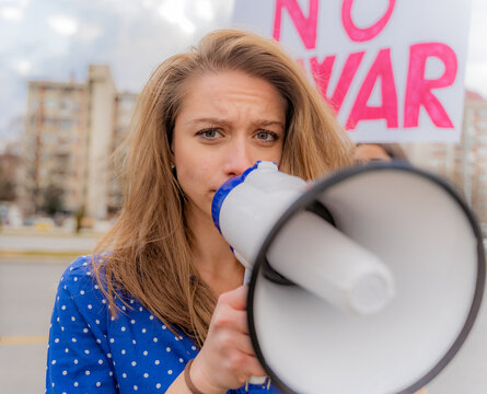 Sad girl talking on the megaphone, close up