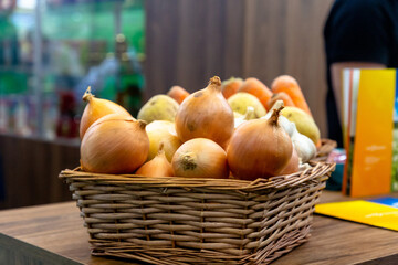 Onions, garlic and potatoes are in a wicker basket