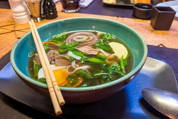 Asian soup with beef, noodles and egg, similar to pho bo or ramen.