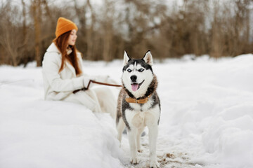 young woman winter outdoors with a dog fun nature winter holidays