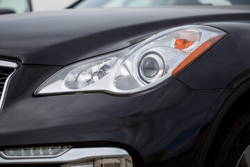 Obraz na płótnie Canvas Headlight of a modern prestigious car close-up with modern optics