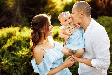 Happy loving family make fun with cute baby, parents play with child, enjoy weekend at the park