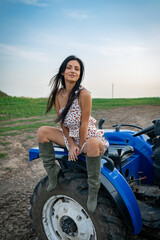 Fototapeta na wymiar Girl with long black hair in the countryside. Ipadrome with horses. Rural landscapes, wild west.