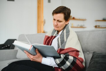 Fototapeta premium Senior woman reading book at home.