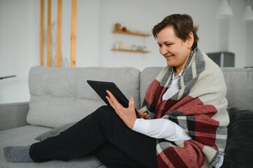 pretty senior woman using tablet computer at home