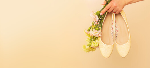 Fashion - spring footwear for woman - banner. Pastel yellow ballet flats shoes and flowers on beige - obrazy, fototapety, plakaty