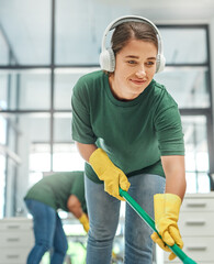 The cleaning squad at your service. Shot of a young woman cleaning an office with her colleague in...