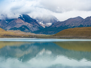 Laguna Amarga (Bitter Lagoon) with breathtaking views of the distinctive three granite peaks of the Paine mountain range. Torres del Paine National Park, southern Patagonia, Magallanes, Chile