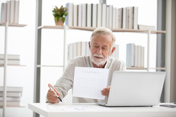 senior businessman checking and reading contract in paper for work