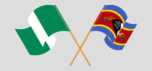 Crossed and waving flags of Nigeria and Eswatini