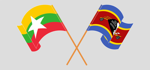 Crossed and waving flags of Myanmar and Eswatini