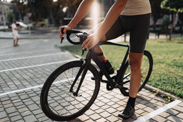 Close up of cyclist in sportswear sitting on bike outdoors