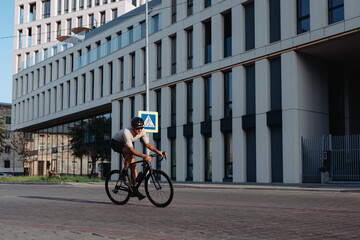 Active man riding bike on city street