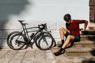Exhausted cyclist relaxing after long ride outdoors