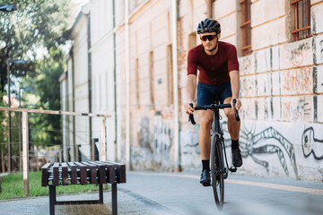 Active cyclist in safety helmet riding bike outdoors