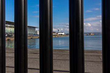 View of the port and the embankment through the fence.