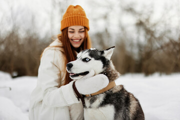 young woman with husky on the snow walk play rest fresh air