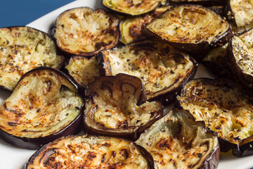 Aubergines are cut into strips and toasted in the oven with salt and spices on a conical plate. Vegetables and food.
