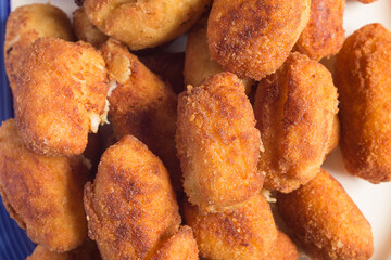 Close-up of a group of golden fried croquettes. Textures and food.
