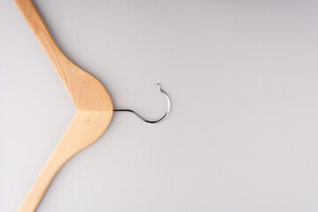Clothes hanger on a gray background. Top view