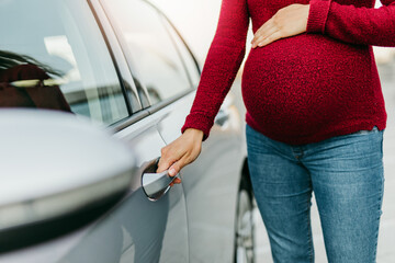 The pregnant woman gets in the car and goes for a medical examination.