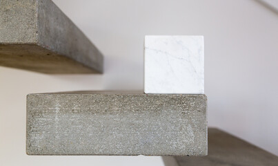 Carrara marble cube on a concrete step block; copy space composition