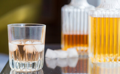 Luxury glass bottles with different alcoholic spirits inside, copy space photo