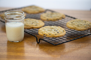 homemade chocolate chip cookies and a glass of milk, intentional shallow depth of field, selective focus