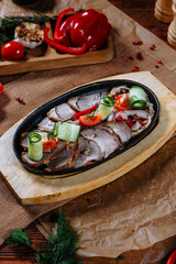 frying pan with meat and fresh vegetables. Top view