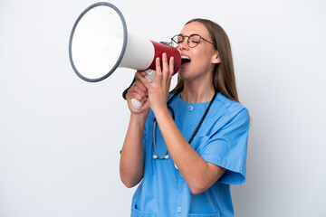 Young nurse caucasian woman isolated on white background shouting through a megaphone