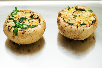 Stuffed mushrooms on a metal tray. Food industry product.