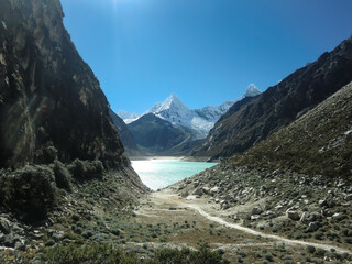 Landscape of a lake between snowy peaks in the mountains of Peru.