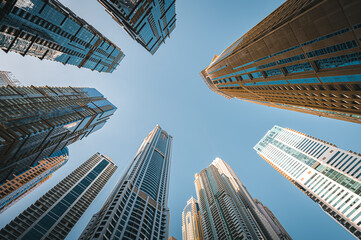 
Modern glass skyscrapers in Dubai with blue sky in background. Impressive architecture of financial district and Dubai marina. 
 - Powered by Adobe