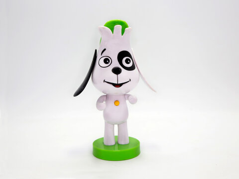 Doki. Toy of the character from the series Doki and his friends from Discovery Kids. 
Plastic figure. Curious dog from the animated television series. Isolated white. Animal. 