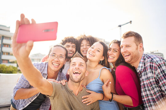 Selfie of happy group of young friends having fun together in a summer day.
