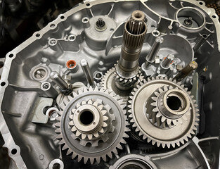 gearbox of an open engine with sprockets, shafts, gearwheels, transmission of a combustion engine, car parts, mechanics, automotive - obrazy, fototapety, plakaty