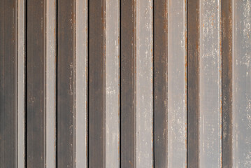 Abstract background texture of a rusty and weathered zigzag sliding gate of an industrial hall