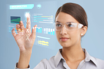 DNA analysis in progress.... Shot of a female scientist using a digital interface to do a DNA analysis.