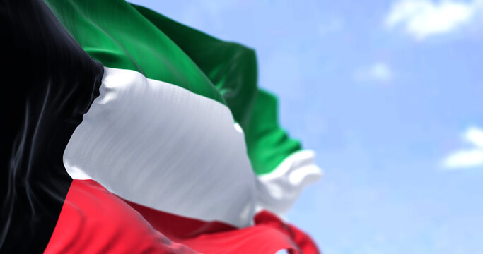 Detail of the national flag of Kuwait waving in the wind on a clear day - Powered by Adobe