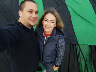 Adventure love couple on hot air balloon watermelon. Man and woman kiss hug love each other. Burner...