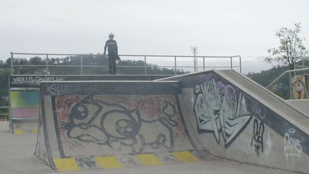 young kid jumps at skatepark