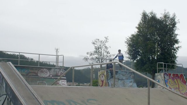 Young boy jumps at skatepark