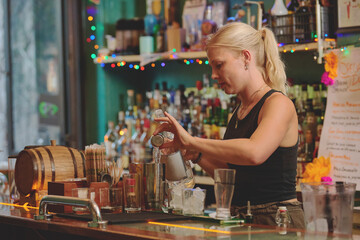 Female barman preparing drinks. cocktail bar Drinks at the bar. Fresh and cold drinks in a bar. Watermelon drink, jamiaca drink, margarita, micheladas.