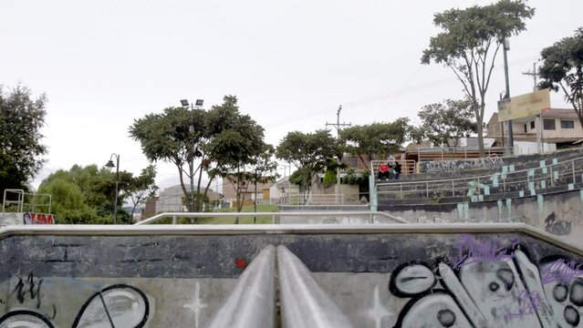 Male rollerblader jumping ramp at skatepark
