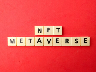 Top view toys word with text NFT METAVERSE on red background.