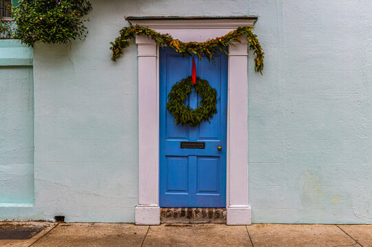 Blue Door With Christmas Wreath In The Historic District, Charleston, South Carolina, USA